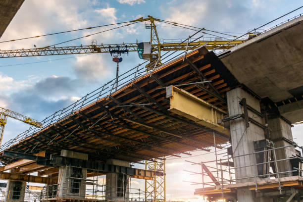 Bridge construction with cranes and steel framework