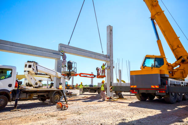 Large crane lifting steel beams at construction site